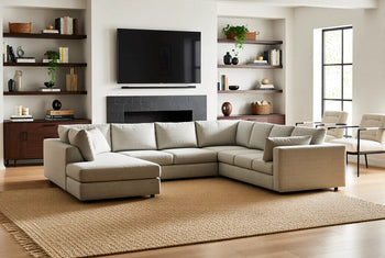 Grey U sectional in living room with tv and bookcases
