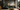 Green sofa in earth-tone living room, 2025 color trend