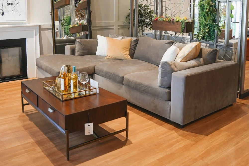 Modern living room with a gray sectional sofa, wooden coffee table, and decorative elements.