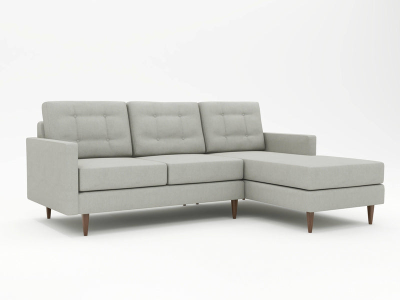 Neutral grey couch with a right hand chaise lounge inclusion