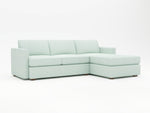 The color of this custom chaise sectional upholstery is "Pool" (light blue)