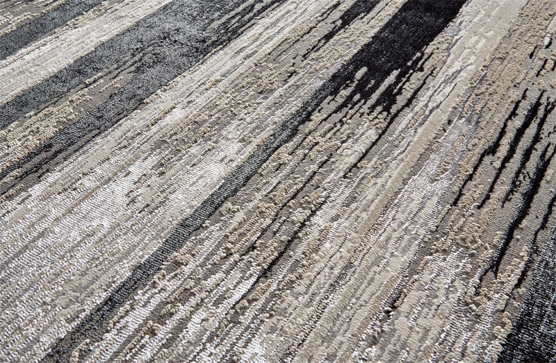 Macro shot showing the incredible variable texture of a contemporary black, tan and white rug surface - Santa Clara Home Furnishings